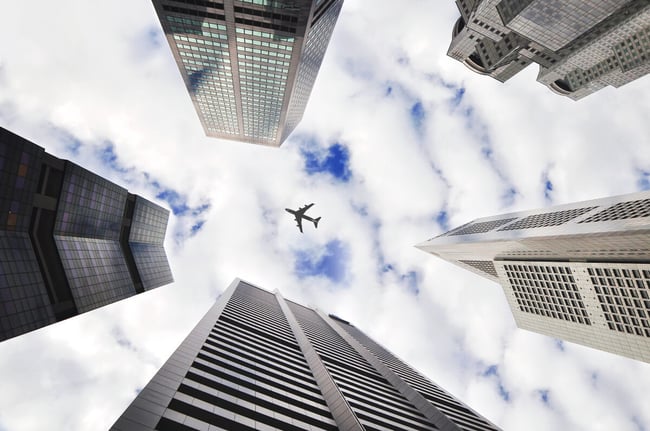 Plane flying over buildings