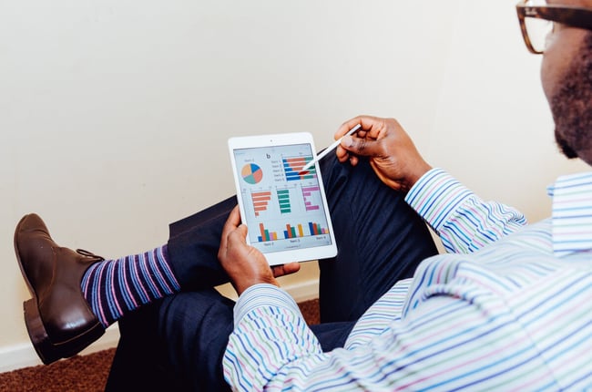 Man sitting, looking at idea challenge data